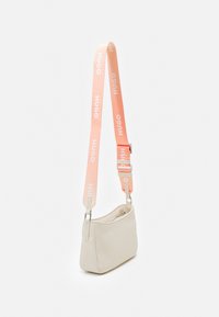 Beige synthetic handbag with a curved shape, featuring a pink strap with "HUGO" text and silver hardware accents.