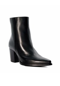 Botte de cheville en cuir noir avec un bout pointu, texture lisse et un talon bloc. La tige présente un design épuré et moderne avec des détails minimaux.