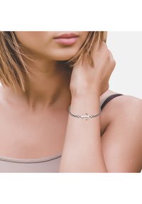 Bracciale ancorato in argento con cordino nero intrecciato, caratterizzato da un design elegante e piccoli dettagli a forma di cuore su entrambi i lati dell'ancora.