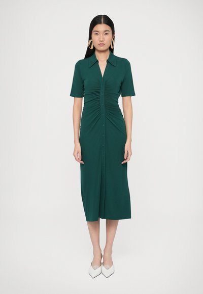 Green, knee-length dress with a collared neckline and short sleeves. Features gathered details at the front and a button-up design.