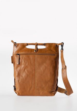 Brown leather crossbody bag with front zipper pocket, top snap closure, and adjustable shoulder strap on plain background.