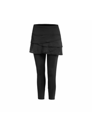 Jupe noire à volants attachée à un legging noir, présentée sur un fond blanc uni.