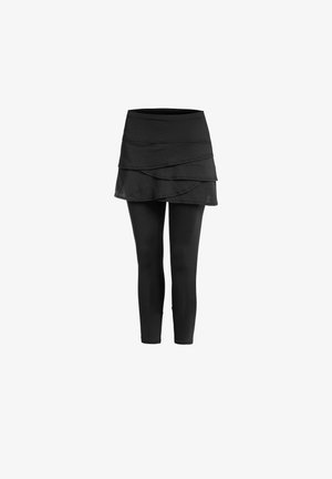 Jupe noire à volants attachée à un legging noir, présentée sur un fond blanc uni.