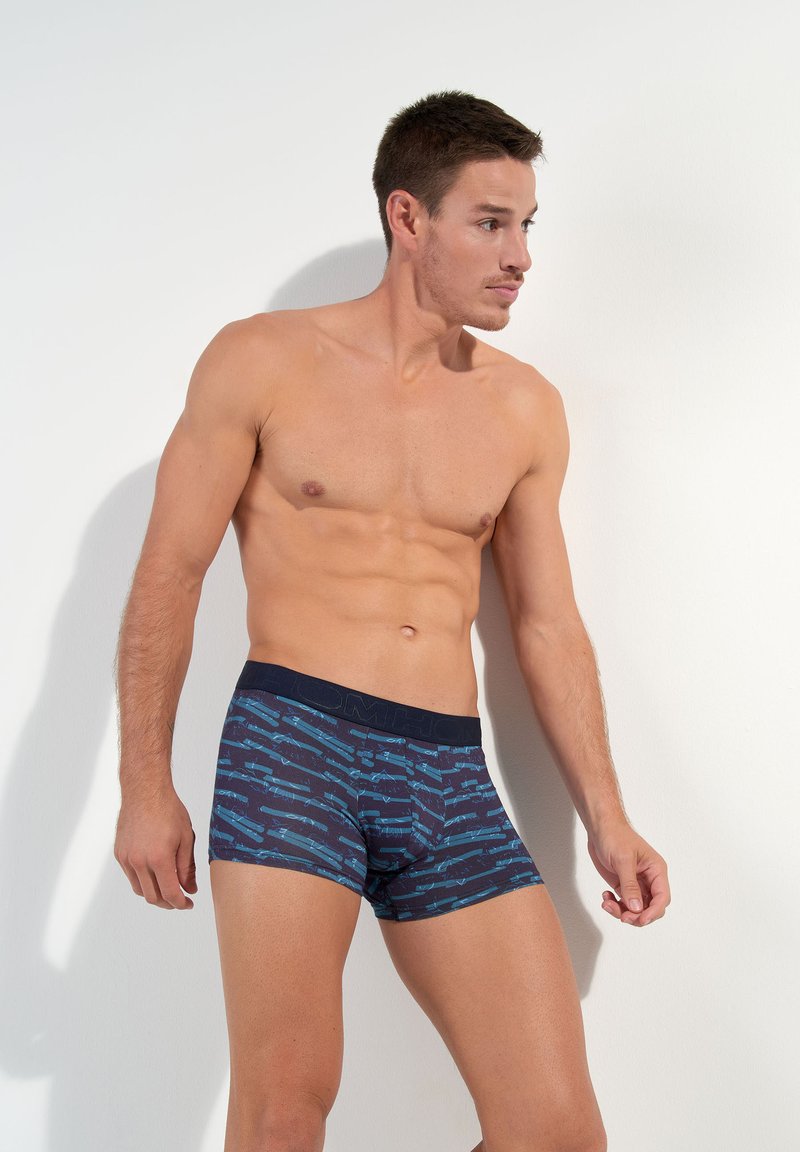 Men's boxer briefs in dark navy with blue diagonal stripes and abstract patterns. Soft fabric with a contrasting waistband.