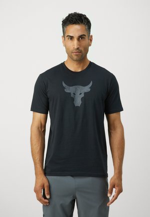 Sort bomulds t-shirt med et gråt tyr-logo på brystet. Rund hals, korte ærmer og en standard pasform. Glat tekstur.