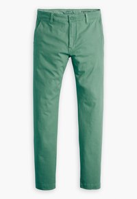 Pantalon chino vert en coton, présentant une coupe tapered standard, un devant plat et des passants de ceinture. Texture lisse sans motifs.