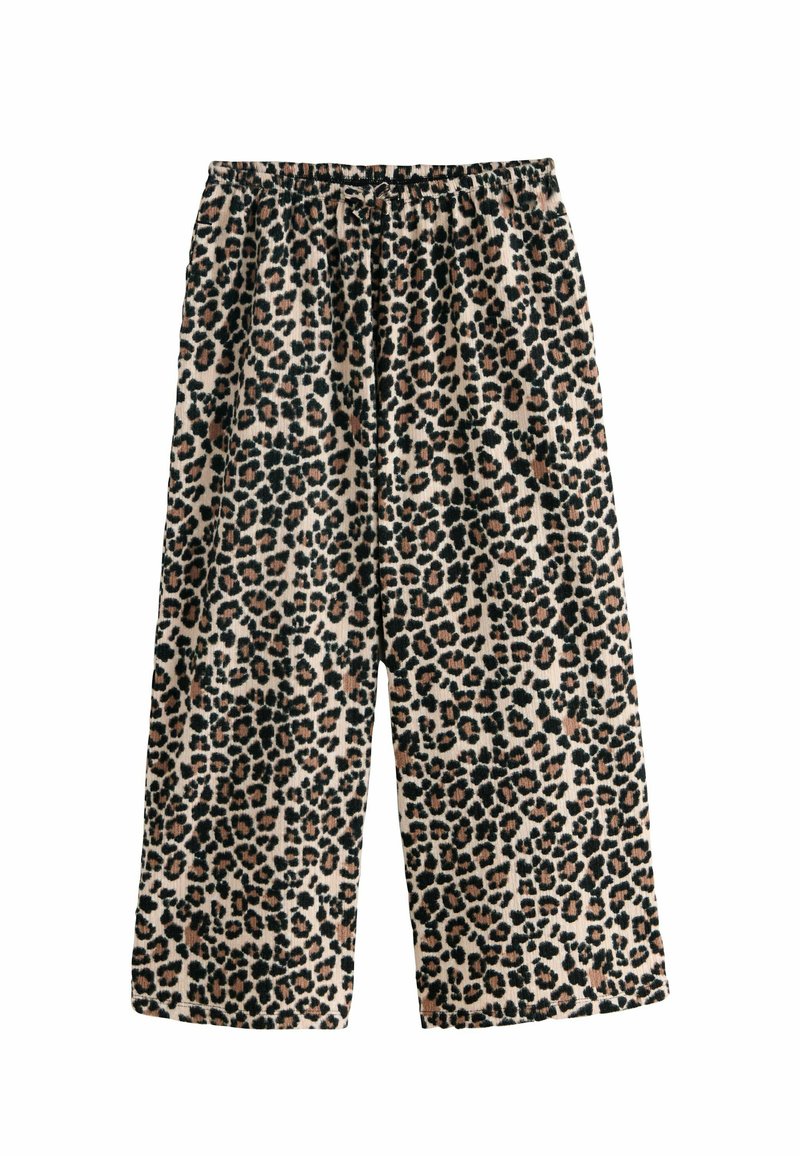 Leopardmønstrede bukser med vidde og elastisk talje. Lavet af blødt stof med sorte og brune pletter på en beige baggrund.