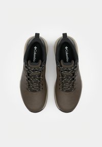 Brown hiking shoes with a smooth leather upper, textured edges, and black accents. Features gray laces and a pull tab on the heel.