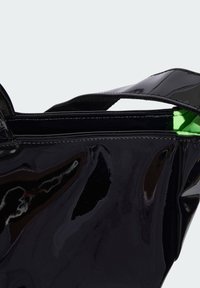 Black patent leather bag with a glossy finish, featuring a green interior and sturdy black straps. Streamlined shape with zipper closure.