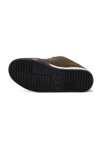 Brown suede sneaker with a textured black rubber sole. Design features include a white midsole and subtle stitching details.
