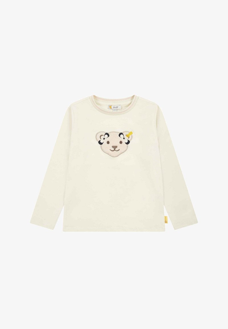 Langärmliges Cremehemd aus weichem Stoff mit besticktem Bärenkopfdesign, schwarzen Akzenten und einem gelben Detail am Ohr.