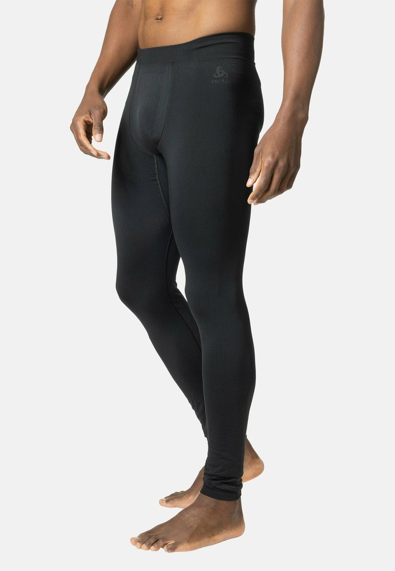 Schwarze, lange, athletische Leggings aus einem glatten, dehnbaren Material. Sie verfügen über ein figurbetontes Design und einen elastischen Bund mit Markendetails.