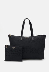 Musta suuri laukku kaksinkertaisilla kahvoilla ja vastaavalla vetoketjupussilla, jotka molemmat esittävät hienovaraisia kuvioita ja kultaisia Michael Kors -logoja.