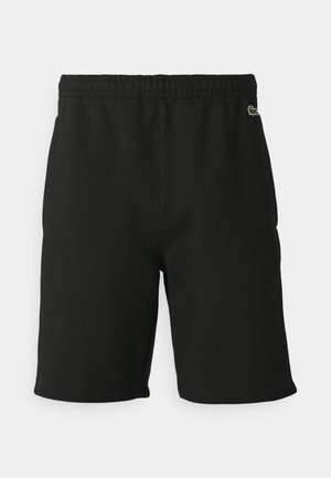 Pantalones cortos de algodón negros con una cintura elástica, que presentan un pequeño logo bordado en la cadera izquierda y una textura suave.