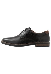 Scarpa oxford in pelle nera con finitura liscia, punta rotonda e accentuazione del tacco marrone. Presenta chiusura con lacci e dettagli di cucitura a contrasto.