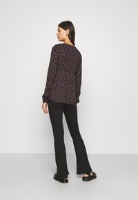 MAMALICIOUS MLLUNA PINTUC FLARED PANT - Calças - black