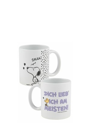White ceramic mugs feature black and purple graphic prints. One shows a cartoon dog with the text "SMAK!" and the other displays "DICH LIEB' ICH AM MEISTEN!" with a character illustration.