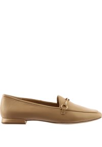 Beige leather loafers with a flat heel, featuring a decorative metal ring and strap accent, smooth texture, and rounded toe design.