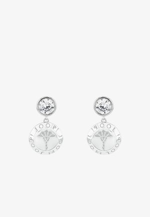 Srebrne kolczyki z kryształowym wkrętem oraz zwisającym okrągłym wisiorkiem o kwiatowym wzorze i napisem z nazwą marki.