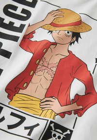 Stylized cartoon man wearing a red open jacket, yellow sash, and a straw hat, holding the hat with one hand while standing confidently.