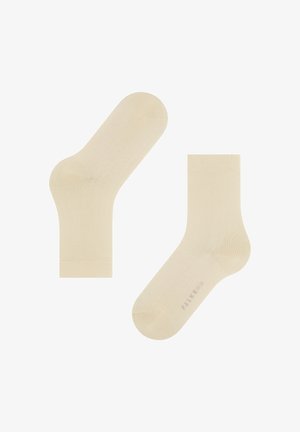 Beige Socken mit glatter Textur, standardmäßiger Knöchelhöhe, verstärkten Zehen- und Fersenbereichen. Markenlogo auf einer Socke sichtbar.