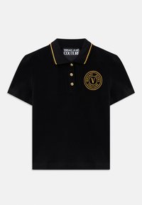Black polo shirt with a gold-accented collar, featuring four gold buttons and a round embroidered logo on the left chest.