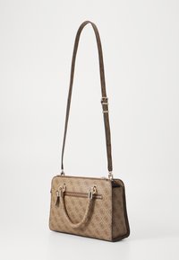 Brown patterned handbag with a rectangular shape, double handles, adjustable shoulder strap, gold hardware, and zipper closure.