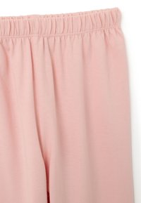 Leggings rosa chiaro con elastico in vita. Realizzati in un tessuto morbido e elasticizzato. Presentano una superficie liscia e un design semplice senza motivi.