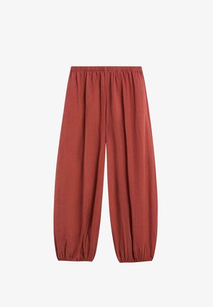 Loose-fit rust-colored pants with elastic waistband and elastic cuffs at ankles, made from lightweight fabric.
