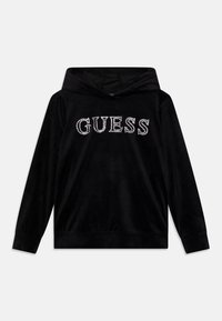 Hoodie in velluto nero con la scritta "GUESS" in strass, maniche lunghe e tasca a marsupio. Tessuto liscio con una vestibilità comoda.