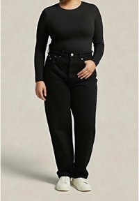 Top nero a maniche lunghe abbinato a pantaloni neri a vita alta. Scarpe bianche completano il look, con design minimalista e vestibilità classica.