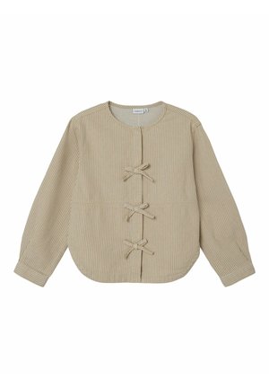 Jasnobeżowa, długa kurtka z długim rękawem, z cienkimi białymi pionowymi paskami i trzema zapięciami na tkaninowe wiązania z przodu.