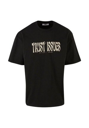Black cotton t-shirt with short sleeves, featuring the printed text "TRUST ISSUES" in white and light beige, with "FRIEND - ENEMY" below.