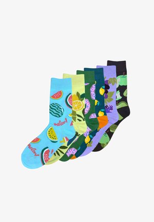 Six colorful socks with fruit patterns including watermelon, lemon, dragon fruit, grapes, and green apple, arranged side by side.