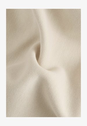 Hellbeige, gemustertes Gewebe mit einem subtilen Webmuster, das weiche Falten und sanfte Knicke zeigt und seine flexible und atmungsaktive Natur hervorhebt.