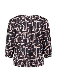 Blusa a motivi nera e crema con maniche a tre quarti, scollatura rotonda e vestibilità ampia. Presenta forme astratte e lievi pences sulla parte posteriore.