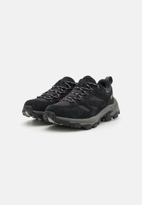 Black hiking shoes with a combination of suede and mesh material, textured rubber sole, reflective laces, and a reinforced toe cap.