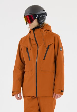 Orange vattentät jacka med hög krage, justerbar huva, svart dragkedja och två bröstfickor. Har en logopatch på ärmen.