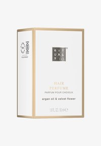 Perfumy do włosów w białym pudełku z złotymi akcentami. Zawiera olej arganowy i kwiat aksamitki, oznaczone certyfikatem przyjaznym dla wegan. 50 ml.