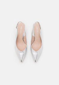 Srebrne metalne slingback balerinke s ostrimi prsti in odprtimi stranmi. Imajo gladko teksturo in blagovno znamko na notranji strani.