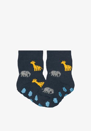 Chaussettes pour bébé bleu marine avec motifs de girafe jaune et d'éléphant gris, munies de grips antidérapants bleus sur la semelle.
