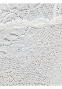 White lace fabric featuring intricate floral patterns, delicate textures, and varied open weaves creating a detailed, sheer appearance.