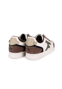 White and brown sneakers featuring suede, leather, and rubber materials. Rounded design with a green logo and contrasting accents.