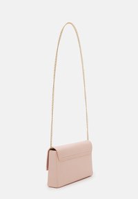 Small rectangular light pink purse with a flap closure and a long thin gold chain strap, shown against a white background.
