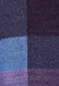 Knit fabric featuring a patchwork design in dark purple, light blue, and lavender shades, showcasing varying textures and stitch patterns.
