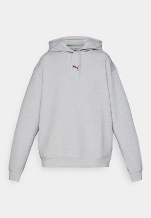 Sivi dukserica s kapuljačom i kengur džeparom. Mekani materijal od mješavine pamuka, rebraste manžete, izvezeni logo na prsima, opušteni kroj.