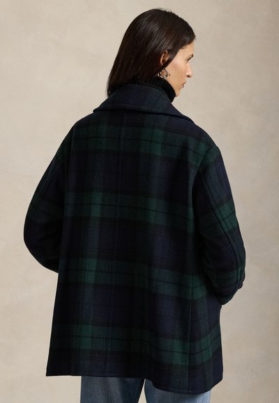 Lõuendriidest villane mantel tumedas mereväe ja rohelises toonis, millel on krae ja lõdvestunud istuvus. Pehme tekstuur, millel on silmatorkav ruuduline muster.