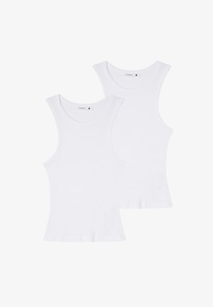 Due magliette senza maniche in cotone bianco con una texture a coste, dotate di spalline larghe e scolli rotondi. Etichette visibili all'interno del collo.