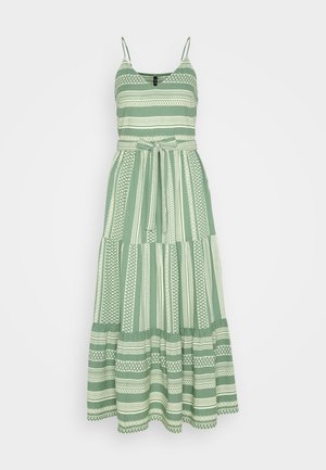 Green and white striped maxi dress with spaghetti straps, featuring a fitted bodice, tiered skirt, and a tied waist detail.