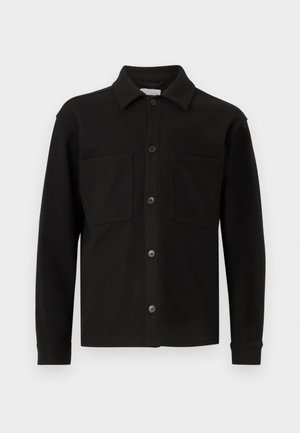 Black button-up shirt made from soft fabric, featuring a collar, two front pockets, and long sleeves with buttoned cuffs.